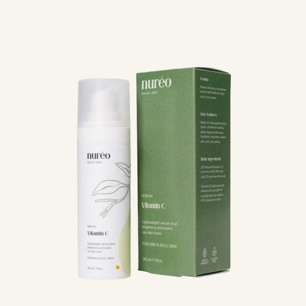 Radiant Boost Vitamin C Serum bottle and packaging on green background.