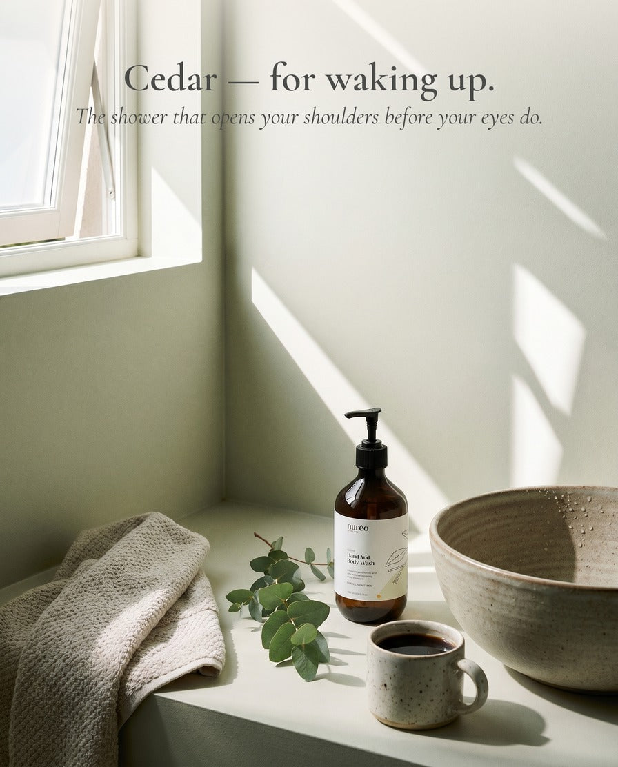 Cedar + Cardamom Ritual bundle hero — two bottles on linen with eucalyptus and ceramic dish