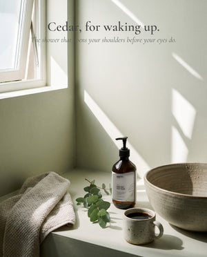 Cedar, for waking up. The shower that opens your shoulders before your eyes do.